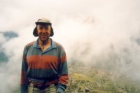 Photograph of Roy Davies with a mist-shrouded Machu Picchu in the background. Taken after walking the Inca Trail, August 1997.